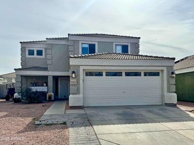 view of front of property with a garage, concrete driveway, a tiled roof, and stucco siding