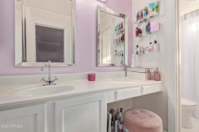 bathroom featuring vanity and toilet