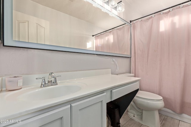 bathroom with toilet, wood finished floors, vanity, and shower / tub combo with curtain