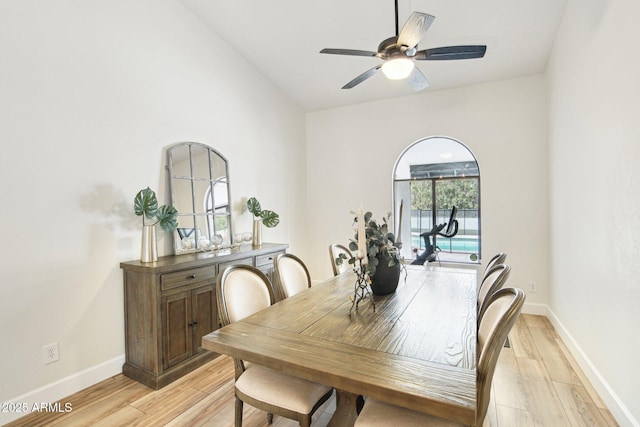 dining room with baseboards, a ceiling fan, and light wood-style floors