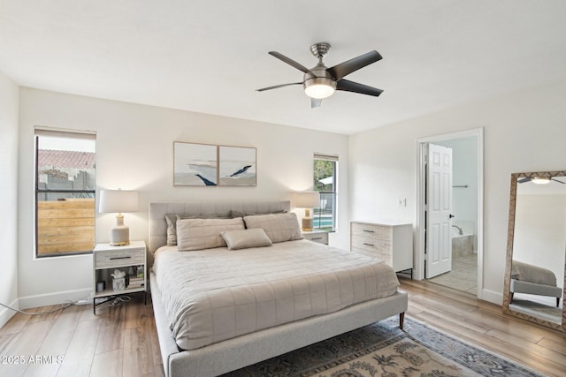 bedroom featuring light wood finished floors, baseboards, and a ceiling fan