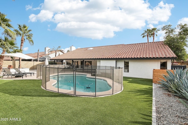 view of pool with a fenced in pool, a patio area, fence, and a lawn