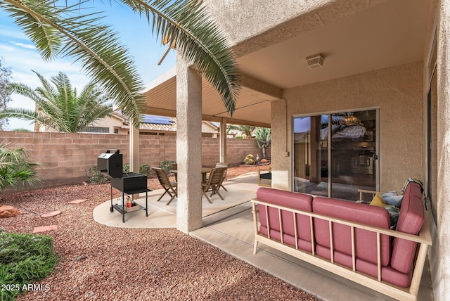 view of patio with outdoor dining space and a fenced backyard