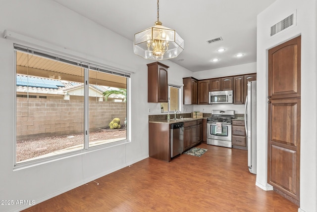 kitchen featuring a notable chandelier, visible vents, appliances with stainless steel finishes, and a sink