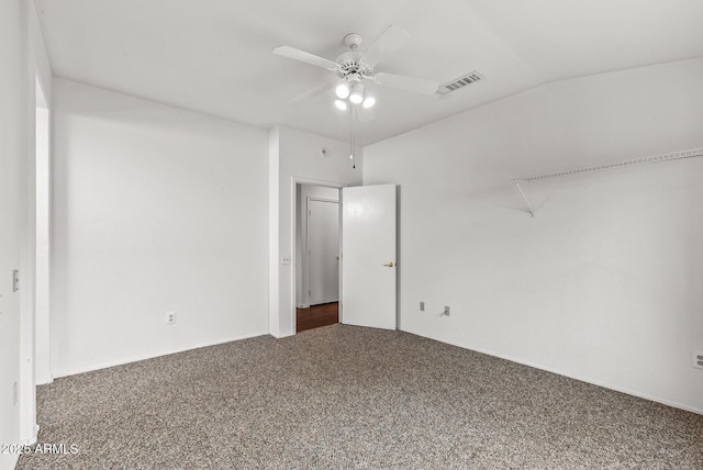 unfurnished bedroom featuring visible vents, lofted ceiling, carpet, and a ceiling fan