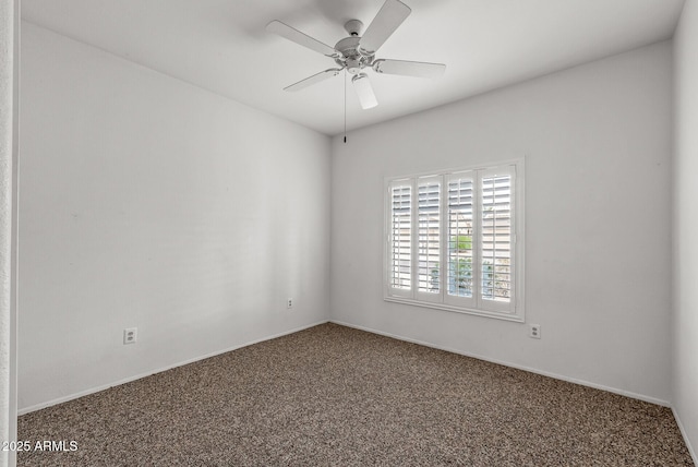 carpeted spare room with a ceiling fan