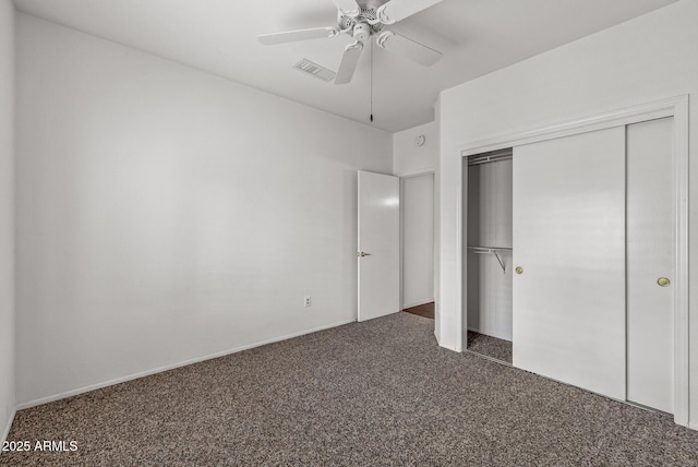 unfurnished bedroom featuring a closet, visible vents, ceiling fan, and dark colored carpet