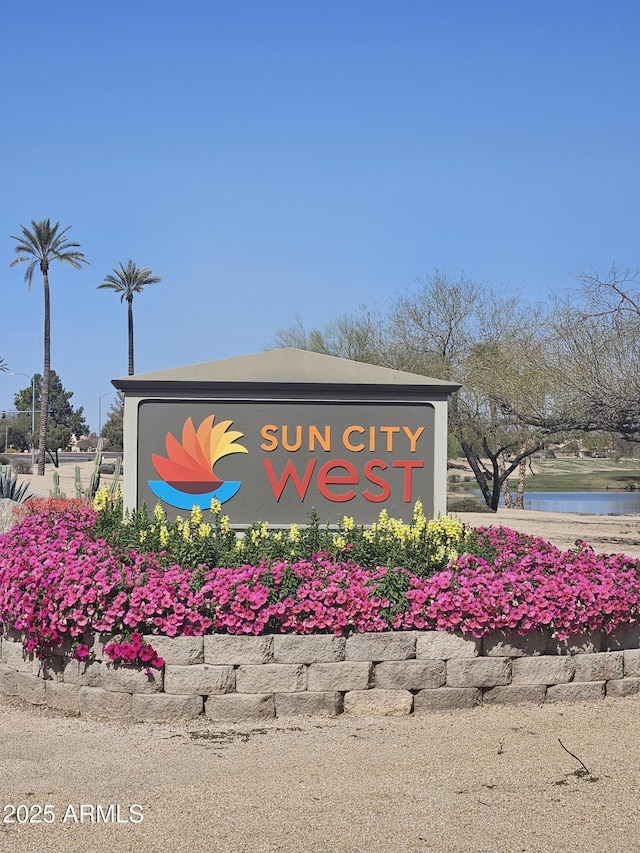 community / neighborhood sign featuring a water view