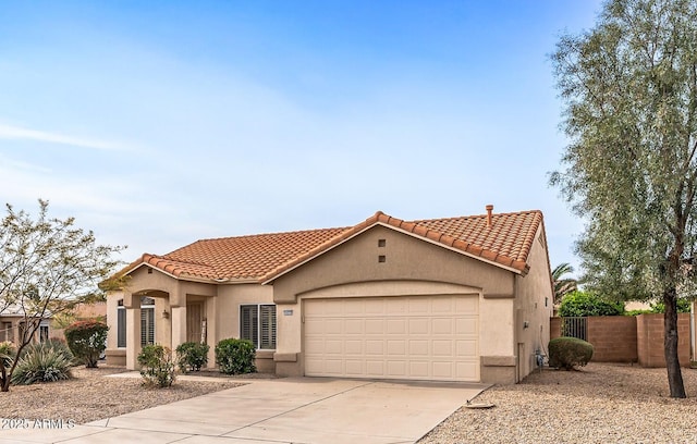 mediterranean / spanish-style house with concrete driveway, a tiled roof, and stucco siding