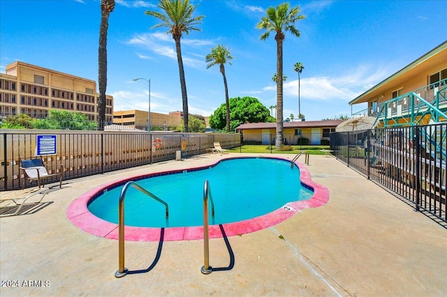 view of swimming pool featuring a patio area