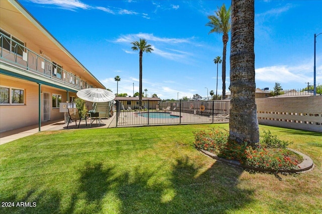 view of yard with a fenced in pool and a patio