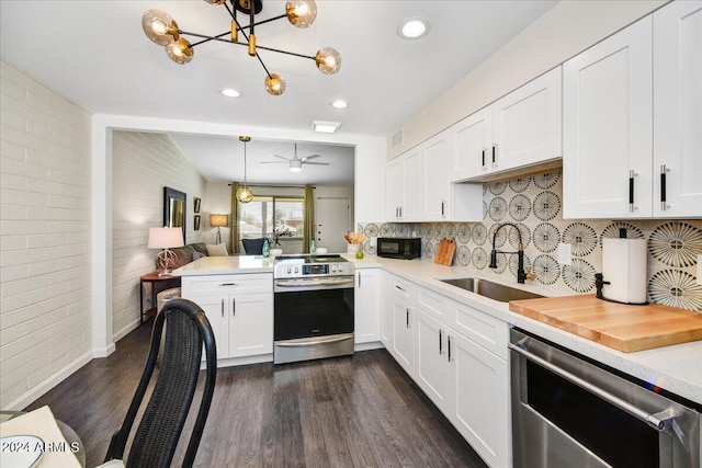 kitchen featuring brick wall, dark hardwood / wood-style flooring, stainless steel appliances, sink, and white cabinets