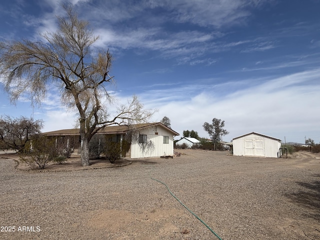 view of side of property featuring an outbuilding and a storage unit