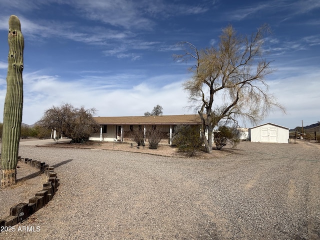 view of front of home with a shed and an outdoor structure