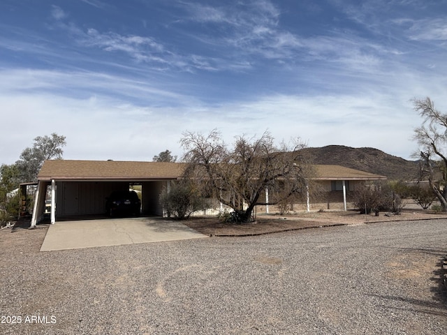 ranch-style home with an attached carport and concrete driveway