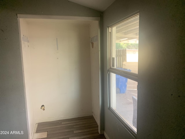 empty room with hardwood / wood-style floors and vaulted ceiling