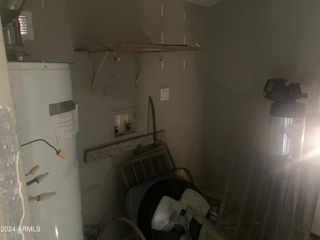 laundry room with washer hookup and water heater