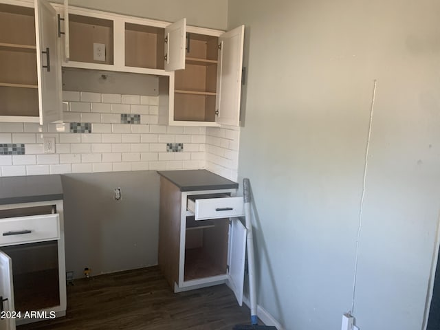 kitchen featuring decorative backsplash and dark hardwood / wood-style floors