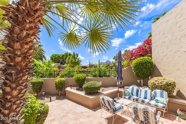 view of patio with fence and an outdoor hangout area