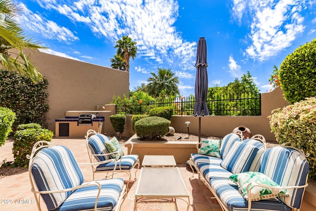 view of patio with fence and outdoor lounge area