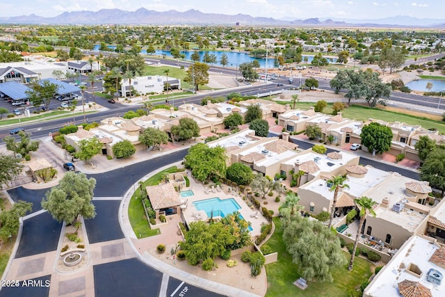 drone / aerial view featuring a residential view and a water and mountain view