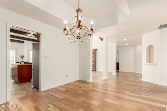 unfurnished dining area featuring visible vents, baseboards, a notable chandelier, recessed lighting, and light wood-style flooring
