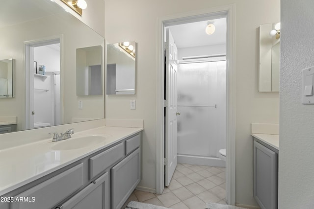 bathroom with tile patterned flooring, a shower stall, vanity, and toilet