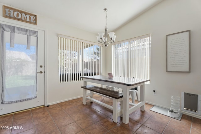 dining space featuring lofted ceiling, baseboards, tile patterned floors, and a chandelier