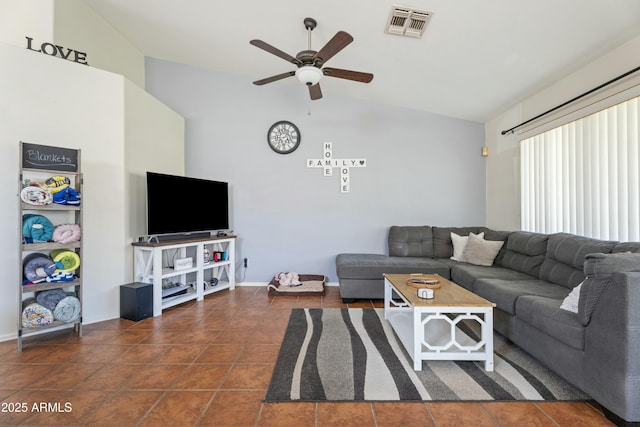 tiled living room featuring lofted ceiling, baseboards, visible vents, and ceiling fan