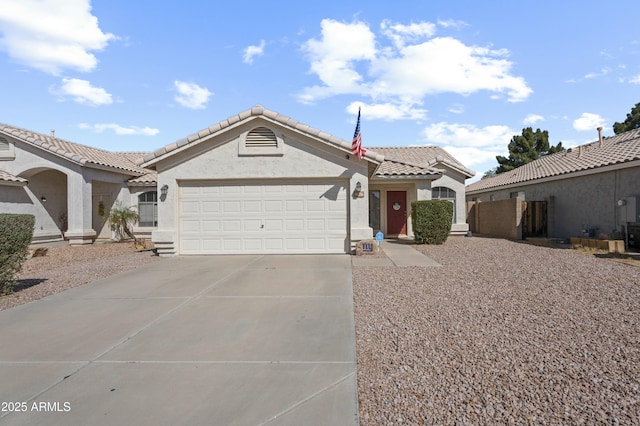 single story home featuring stucco siding, driveway, a tile roof, and a garage