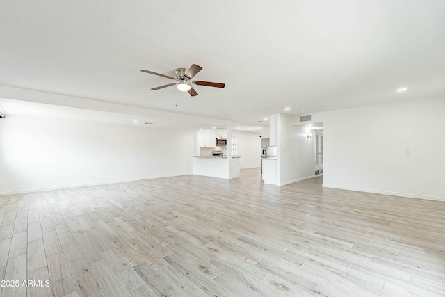 3743 E Coronado Rd, Phoenix, AZ 85008 - unfurnished living room featuring light wood-style floors, baseboards, a ceiling fan, and visible vents