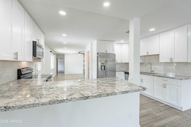 3743 E Coronado Rd, Phoenix, AZ 85008 - kitchen with light wood-style flooring, a ceiling fan, recessed lighting, a sink, and stainless steel appliances
