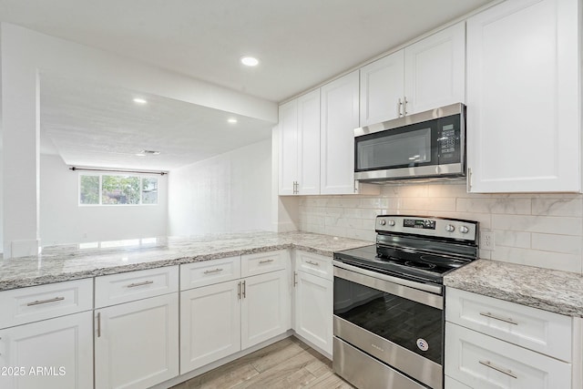 3743 E Coronado Rd, Phoenix, AZ 85008 - kitchen with appliances with stainless steel finishes, decorative backsplash, light stone counters, and white cabinets