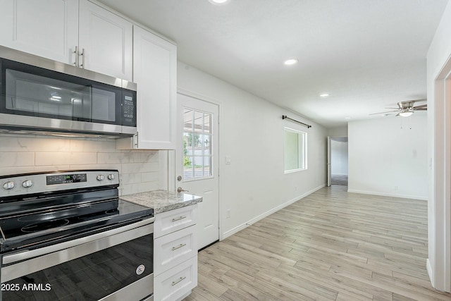3743 E Coronado Rd, Phoenix, AZ 85008 - kitchen with baseboards, recessed lighting, white cabinetry, backsplash, and stainless steel appliances