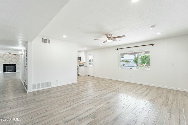 3743 E Coronado Rd, Phoenix, AZ 85008 - unfurnished living room with light wood-type flooring, ceiling fan, baseboards, and visible vents