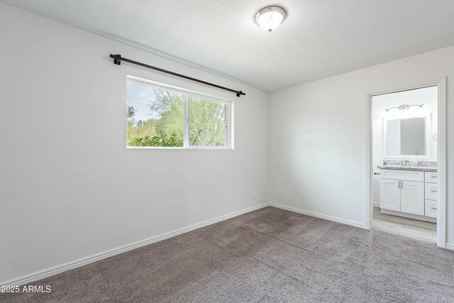 3743 E Coronado Rd, Phoenix, AZ 85008 - unfurnished bedroom with light carpet, ensuite bathroom, and baseboards