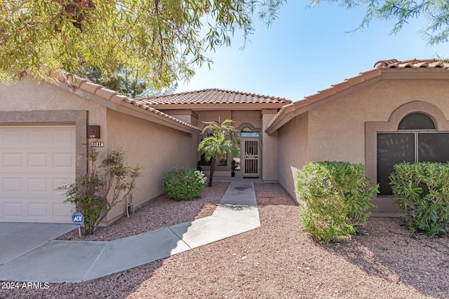 view of exterior entry featuring a garage