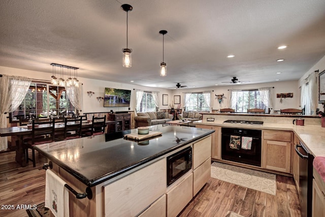 8894 W Lufkin Dr, Pine, AZ 85544 - kitchen with black appliances, light wood finished floors, light brown cabinets, open floor plan, and recessed lighting