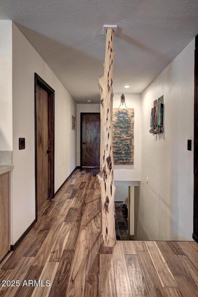 8894 W Lufkin Dr, Pine, AZ 85544 - hallway featuring wood finished floors and a textured ceiling