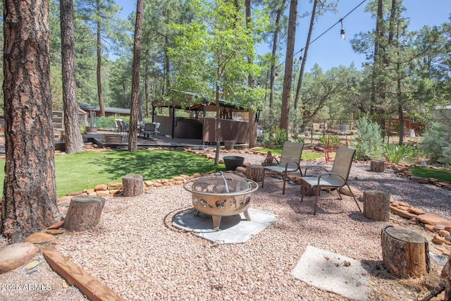 8894 W Lufkin Dr, Pine, AZ 85544 - view of green lawn with an outdoor fire pit and a hot tub