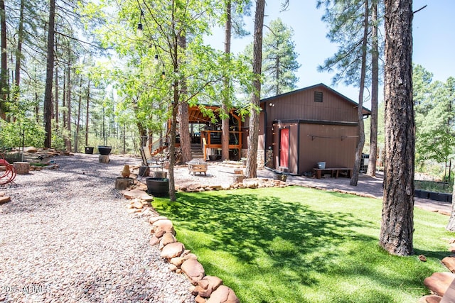 8894 W Lufkin Dr, Pine, AZ 85544 - view of grassy yard featuring an outbuilding and an outdoor fire pit