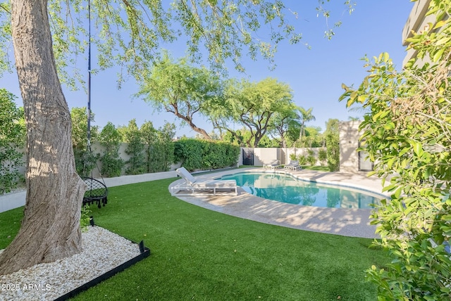 view of swimming pool featuring a patio, a lawn, a fenced in pool, and a fenced backyard