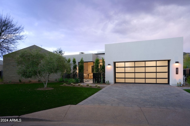 modern home featuring a garage and a front lawn