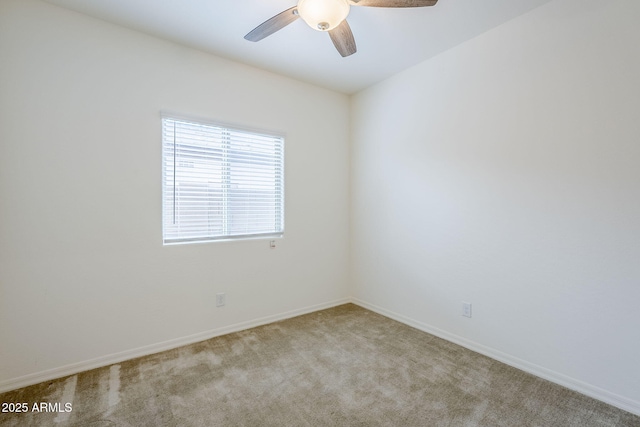 empty room featuring light carpet, ceiling fan, and baseboards