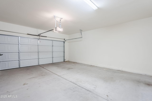 garage with baseboards and a garage door opener