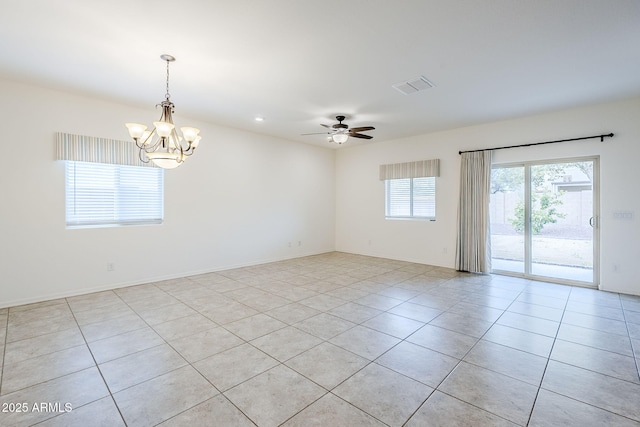 unfurnished room with ceiling fan with notable chandelier, visible vents, baseboards, and light tile patterned flooring