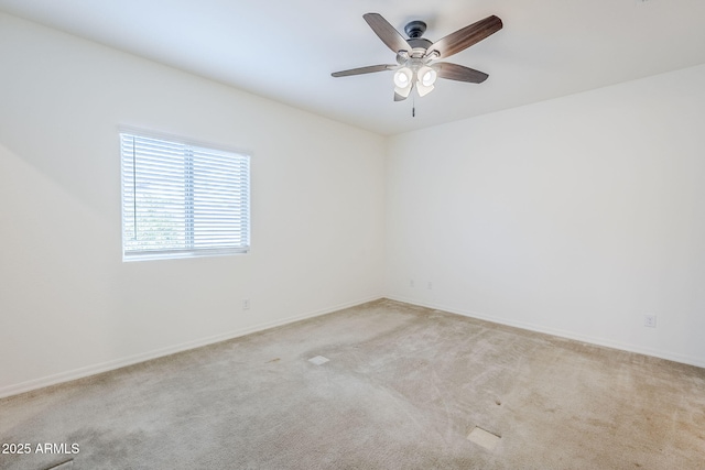 unfurnished room with a ceiling fan, light carpet, and baseboards