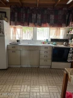 kitchen featuring white cabinets, white appliances, and sink