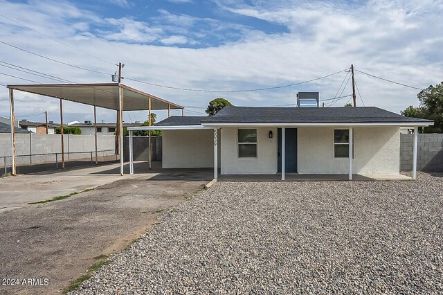 rear view of house featuring a carport