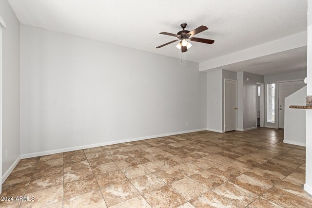 spare room featuring ceiling fan and a textured ceiling